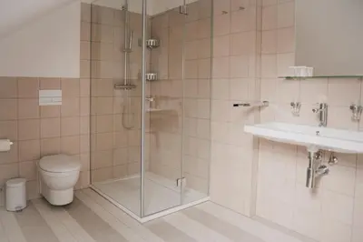 a bathroom with a shower and a toilet and a sink at High Heaven in Prague