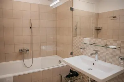 a bathroom with a sink and a shower and a tub at High Heaven in Prague