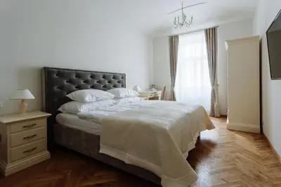 a bedroom with a large bed with a black headboard at High Heaven in Prague