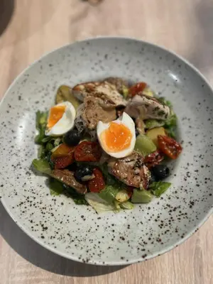 a plate of food with an egg and vegetables at Penzion Marjána in Mníšek pod Brdy