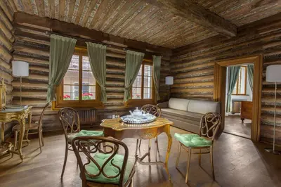 a living room with a couch and a table and chairs at Hotel At the Green Grape in Prague