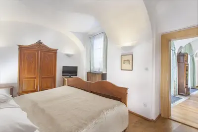 a bedroom with a large bed and a window at Hotel At the Green Grape in Prague