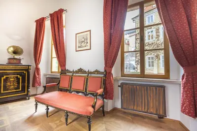 a room with a chair and a window at Hotel At the Green Grape in Prague