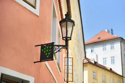 a street light attached to the side of a building at Hotel At the Green Grape in Prague