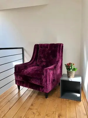 a purple chair in a room with a table at CE Apartment Prague Castle in Prague