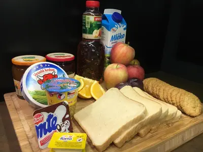 a cutting board with a sandwich and other food on it at CE Apartment Prague Castle in Prague