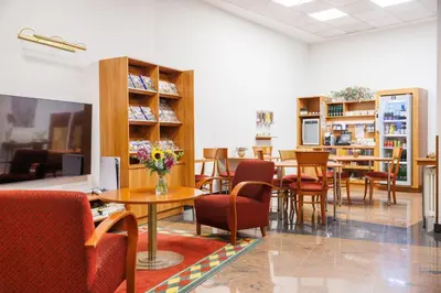 a restaurant with tables and chairs in a room at Hapimag Apartments Prague in Prague