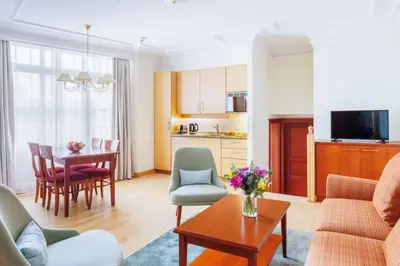 a living room with a couch and a table at Hapimag Apartments Prague in Prague