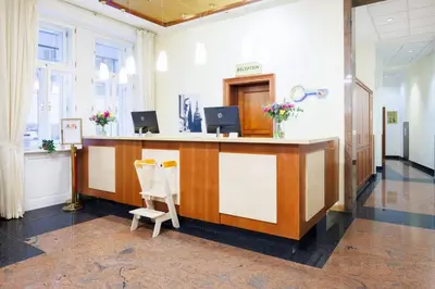 a lobby with a reception desk in a building at Hapimag Apartments Prague in Prague