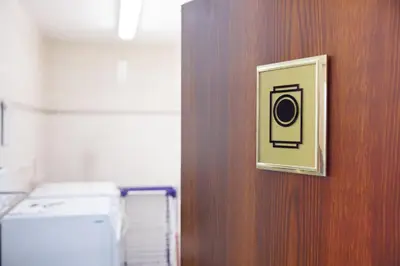 a door with a picture of a washing machine on it at Hapimag Apartments Prague in Prague