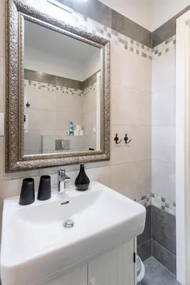 a bathroom with a white sink and a mirror at Romantic designer apartment Prague in Prague