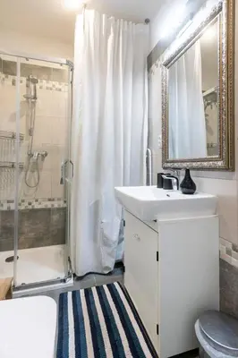 a bathroom with a sink and a shower at Romantic designer apartment Prague in Prague