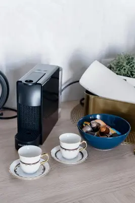 a coffee maker and two cups on a table at Romantic designer apartment Prague in Prague