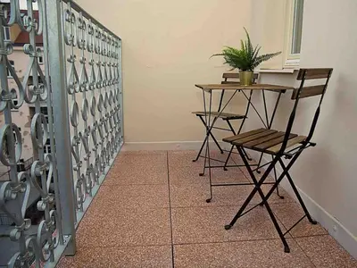 a room with a table and a chair and a plant at Romantic designer apartment Prague in Prague