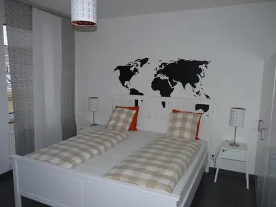 a bedroom with two beds with a map on the wall at The modern apartment in Prague