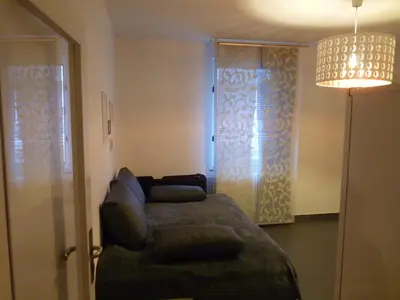 a room with a glass shower door with a couch at The modern apartment in Prague