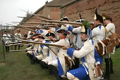 a group of men in historical uniforms holding rifles at Parkhotel Terezín in Terezín