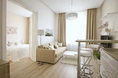 a white living room with a bed and a couch at Luxury Center Apt. Charles bridge walking distance in Prague