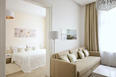 a bedroom with a bed and a couch and a mirror at Luxury Center Apt. Charles bridge walking distance in Prague