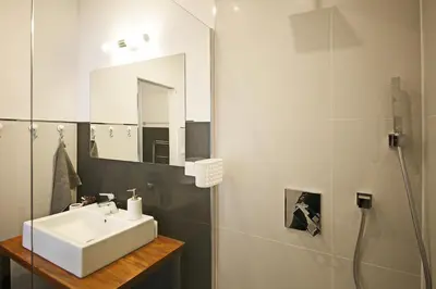 a bathroom with a white sink and a mirror at Luxury Center Apt. Charles bridge walking distance in Prague
