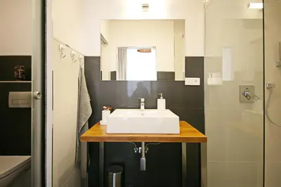 a bathroom with a white sink and a shower at Luxury Center Apt. Charles bridge walking distance in Prague