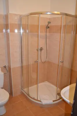 a shower stall in a bathroom with a toilet at Hotel Bohemians in Prague