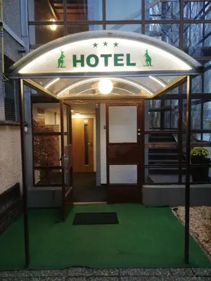 a hotel with a sign on the front of it at Hotel Bohemians in Prague