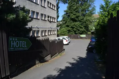 a hotel sign on a fence next to a building at Hotel Bohemians in Prague