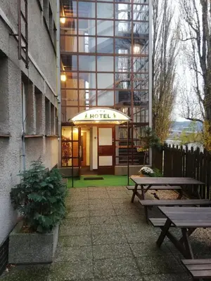 a hotel entrance with benches in front of a building at Hotel Bohemians in Prague