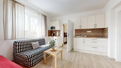 a living room with a couch and a table at Apartmán Dubová in Milovice