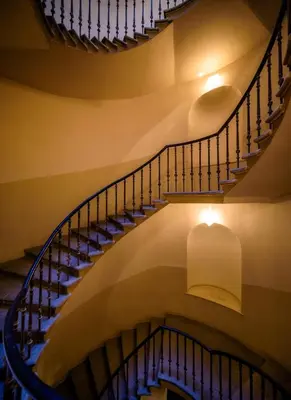 a spiral staircase in a building with a light fixture at Amazing Harry Potter's apt. at Old Town in Prague