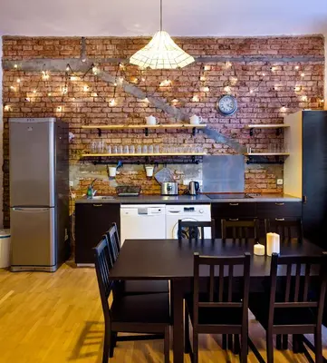 a kitchen with a dining table and a brick wall at Amazing Harry Potter's apt. at Old Town in Prague
