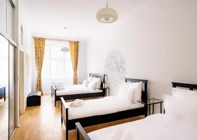 a room with three beds and a window at Amazing Harry Potter's apt. at Old Town in Prague