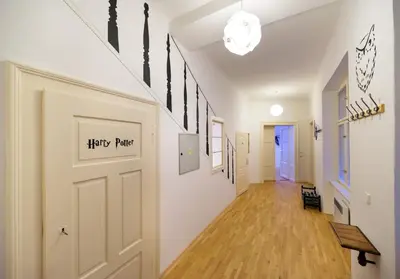 a hallway with a white door and a wooden floor at Amazing Harry Potter's apt. at Old Town in Prague