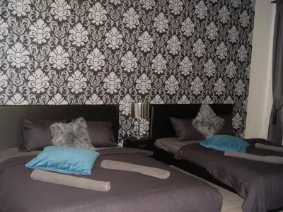 a bedroom with two beds and a wallpaper at Andel Centre SPIRIT in Prague