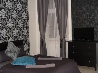 a bedroom with a bed and a window with curtains at Andel Centre SPIRIT in Prague