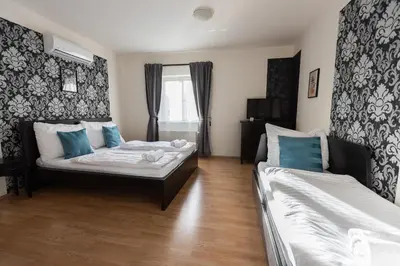 a living room with two beds and a window at Andel Centre SPIRIT in Prague