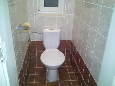 a bathroom with a toilet in a tiled room at Apartment in the centre in Prague