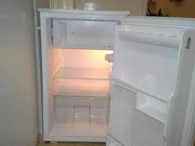 an empty refrigerator with its door open in a kitchen at Apartment in the centre in Prague