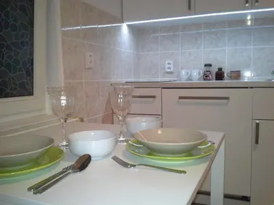 a kitchen with a table with bowls and wine glasses at Apartment in the centre in Prague