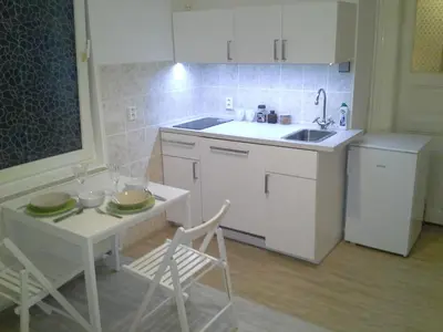 a kitchen with a sink and a table with chairs at Apartment in the centre in Prague