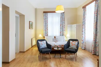 a dining room table with a vase of flowers on it at Hotel Orion in Prague