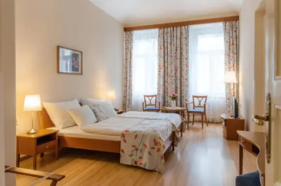 a bedroom with a bed and a window at Hotel Orion in Prague
