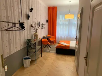 a bedroom with a bed and a desk and a table at Great place near city centre in Prague