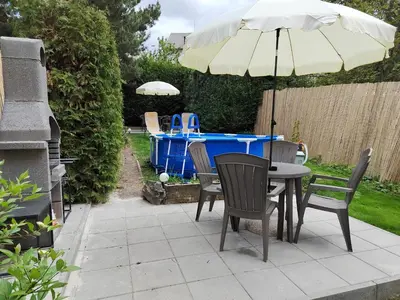 a table and chairs with an umbrella on a patio at Císařka Apartments in Prague