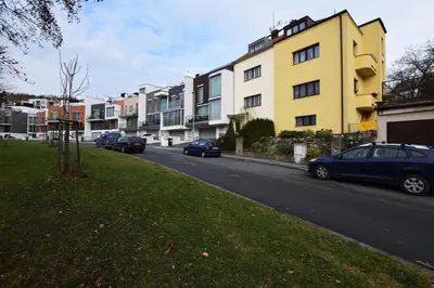 a street with cars parked in front of buildings at Císařka Apartments in Prague