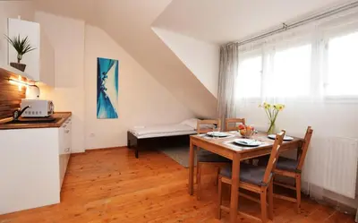 a kitchen and a dining room with a table and chairs at Císařka Apartments in Prague