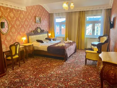 a bedroom with a bed and a table and chairs at SPA Hotel Liliova Prague Old Town in Prague