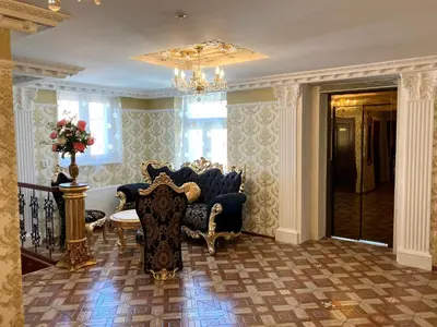 a living room with blue chairs and a chandelier at SPA Hotel Liliova Prague Old Town in Prague
