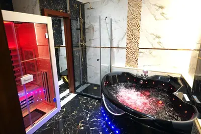 a bathroom with a black tub and a shower at SPA Hotel Liliova Prague Old Town in Prague